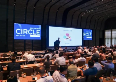 Large audience seated in conference hall watching presentation at CIRCLE 2025 Vietnam.